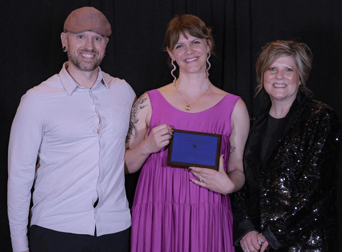 Lunchbox posing with award with Lori Schaefer-Weaton.