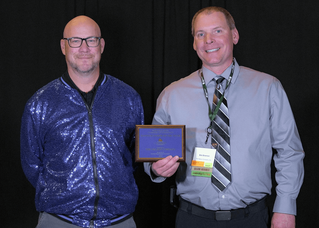 Chad Christensen, president of Fairfield Manufacturers Association presents Manufacturer of the Year Award to The Nelson Company.